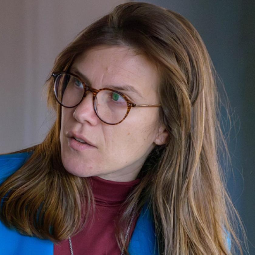 Image of a woman wearing glasses looking to her right