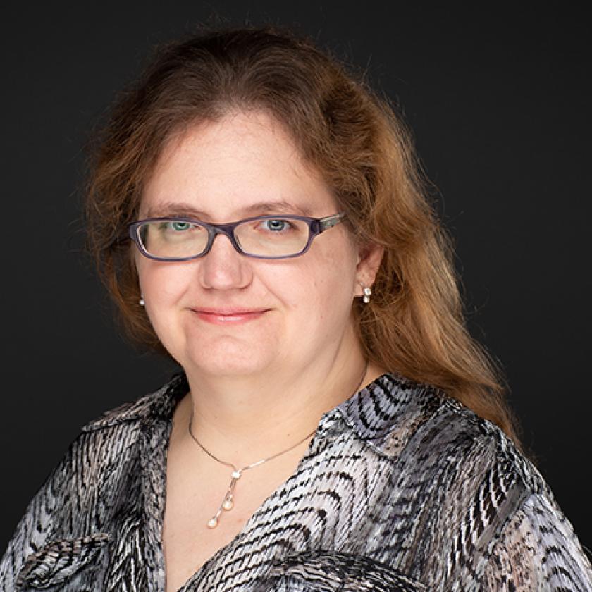 a person wearing glasses and a black and white shirt