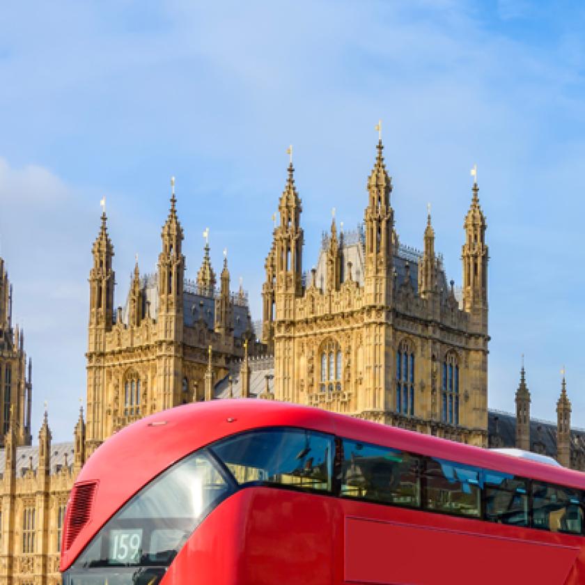 Image of double decker buses in front of a building