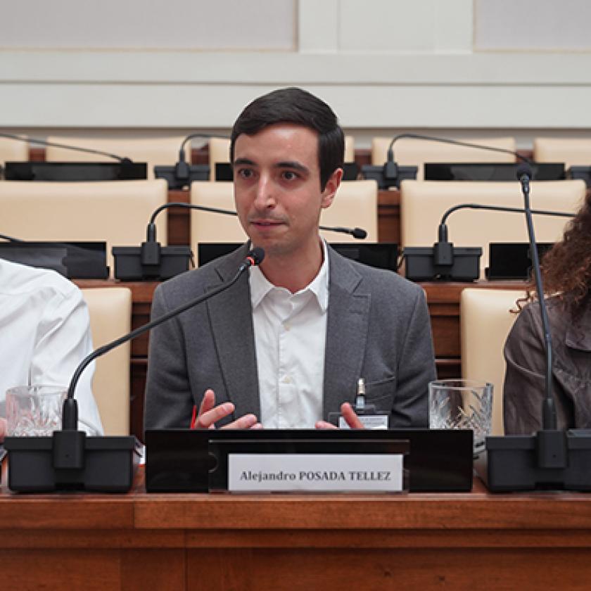 Three people sitting at a podium