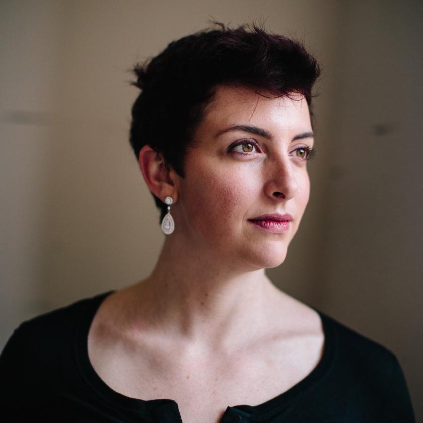 a side profile of a woman in a black top