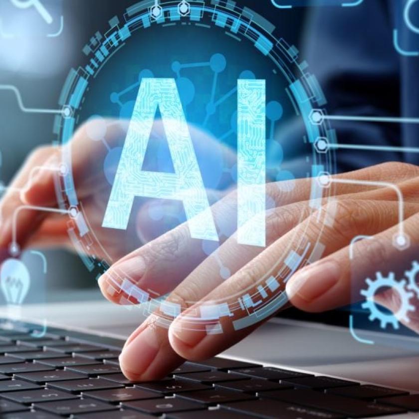 hands typing on keyboard with AI in foreground