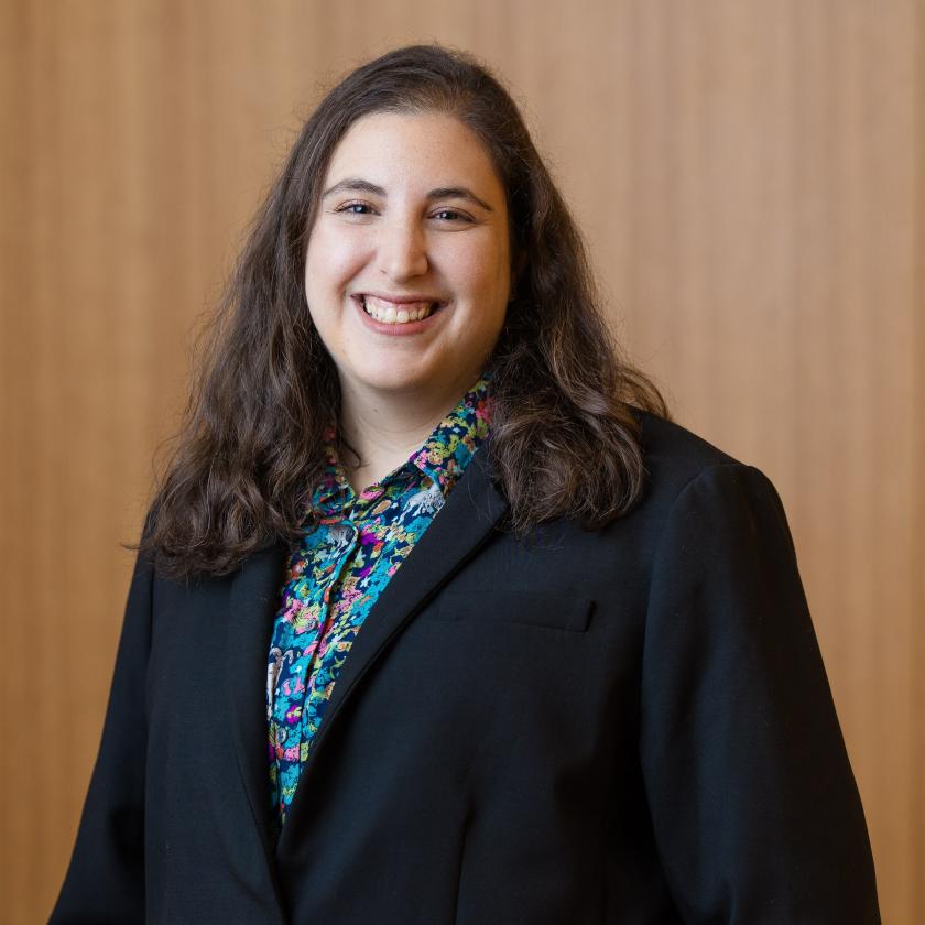 image of a woman wearing a dark jacket smiling at the camera