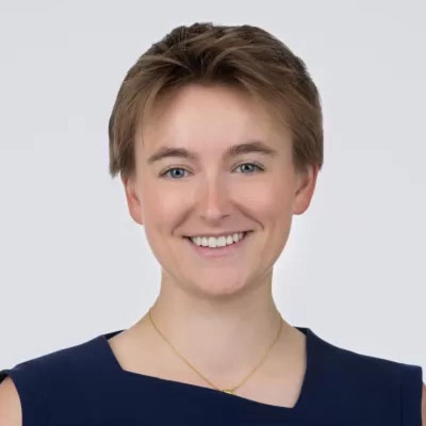 a woman wearing a black top smiling at the camera