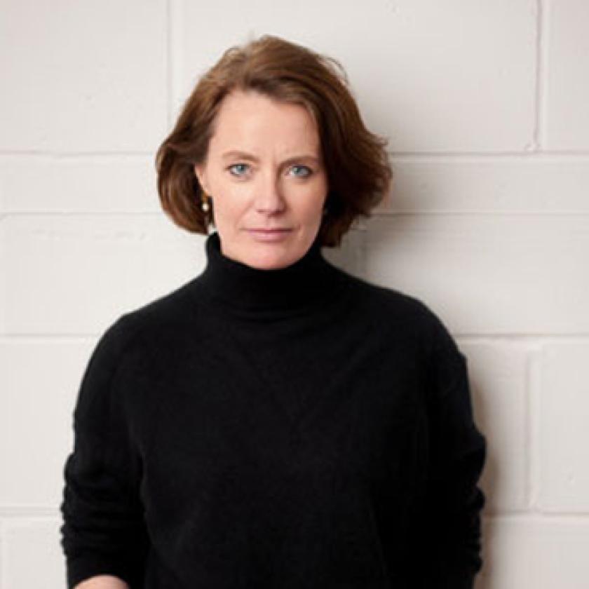 Image of a woman wearing a dark top smiling at the camera