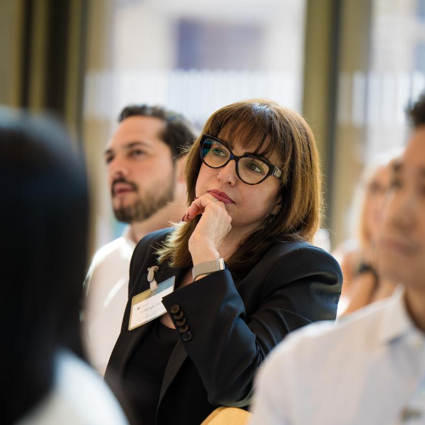 side image of an audience sat listening to a lecture