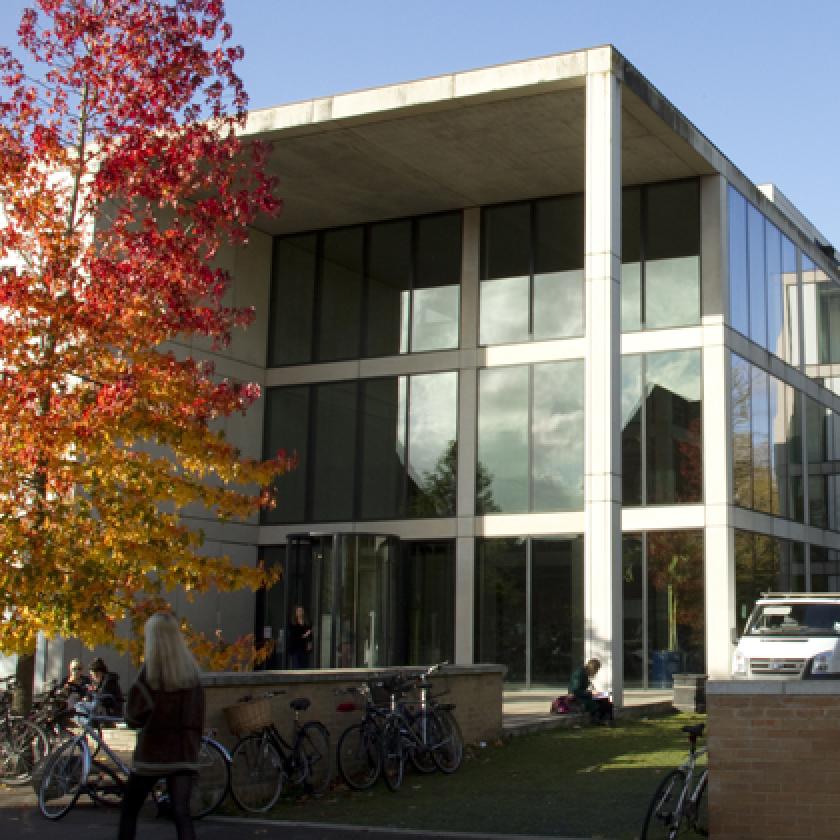 Image of the front of a building with trees to either side