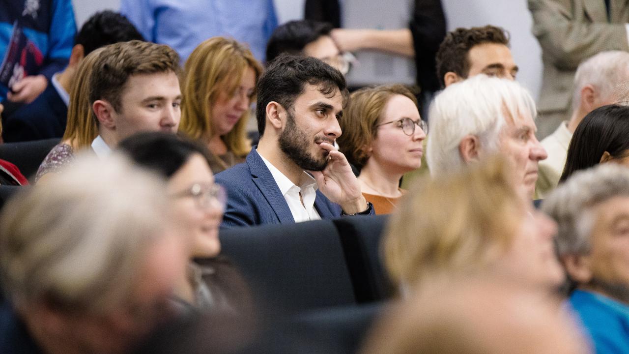 image of an audience of people listening to a lecture