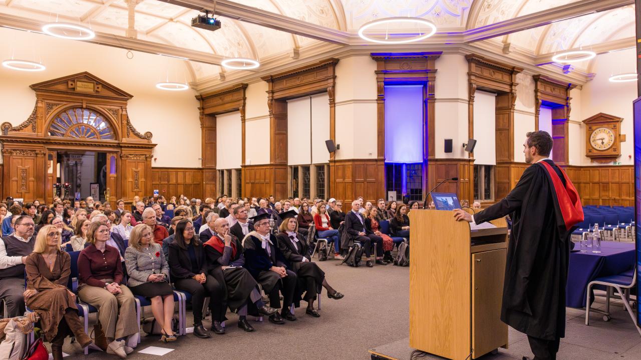 image of a man at a lectern in front of an audience