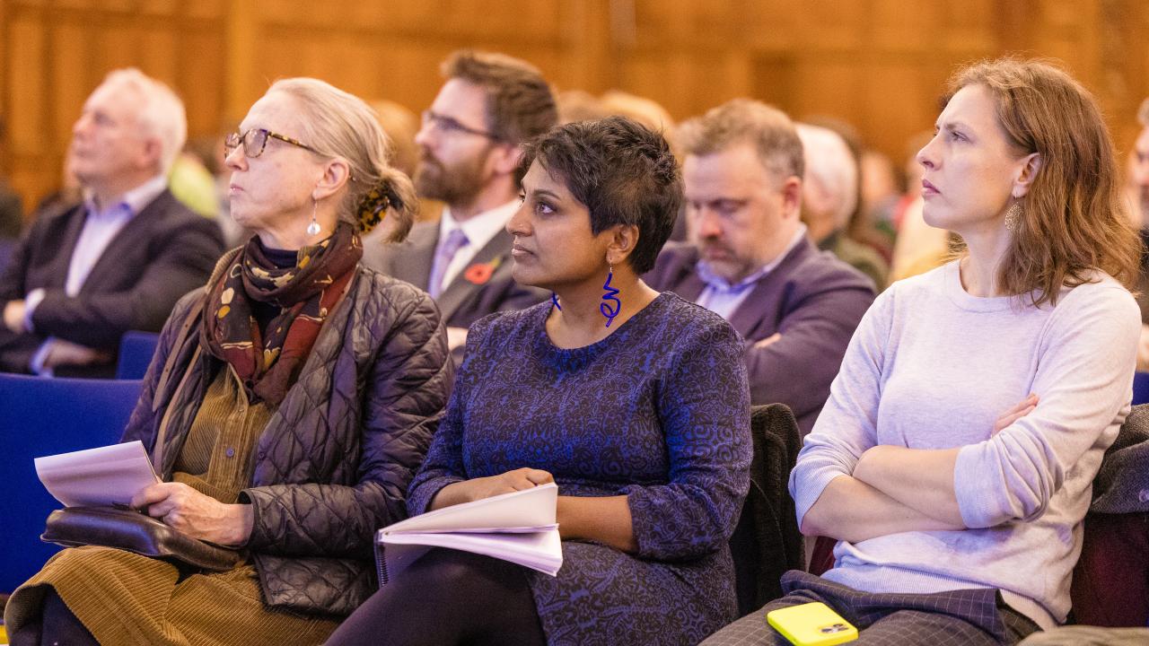 side image of an audience listening to a lecture