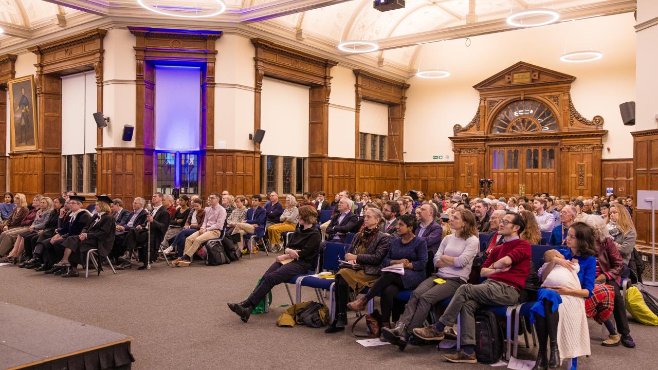 front image of an audience listening to a lecture