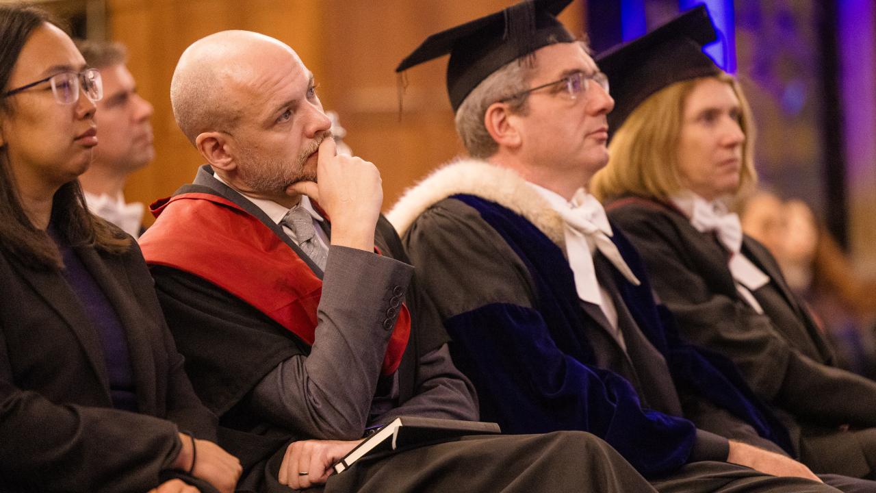 close up image of five members of an audience listening to a lecture