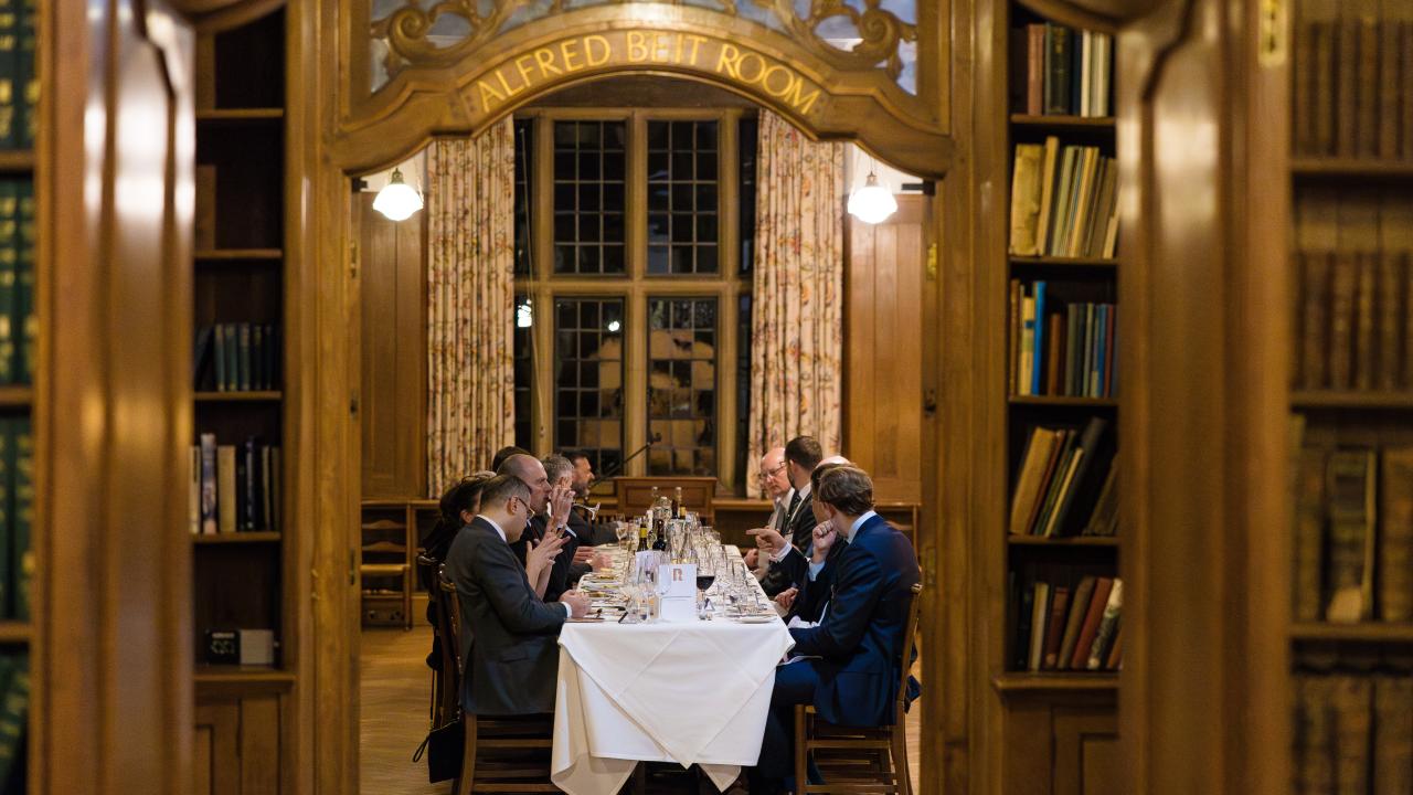 image through an arch of people sat at a table eating