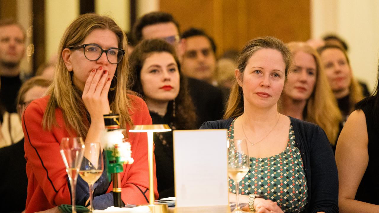 image of a group of people sat listening to a lecture