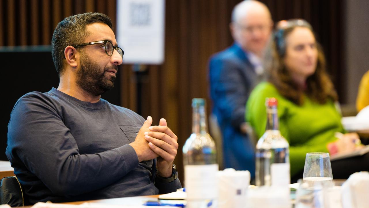 side image of three people sat at a table