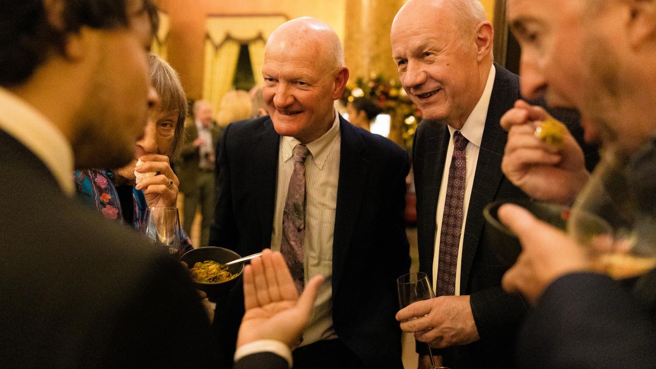 image of five people stood in a circle talking
