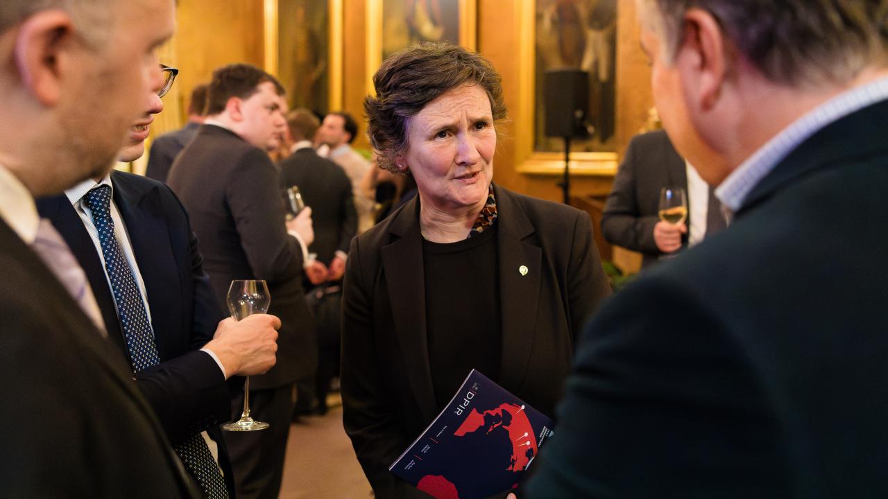 image of three people stood in a circle talking