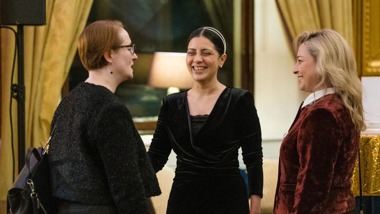 image of three people stood talking