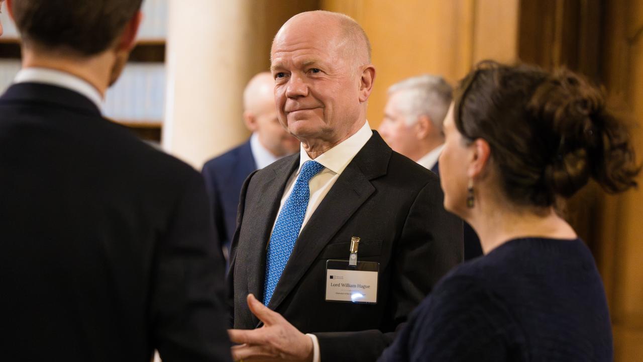 image of three people stood in a circle talking