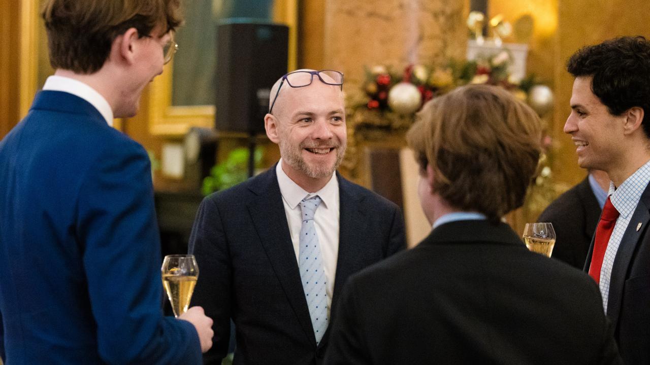image of four people stood talking