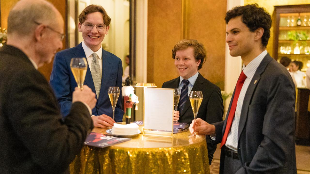 image of four people stood talking