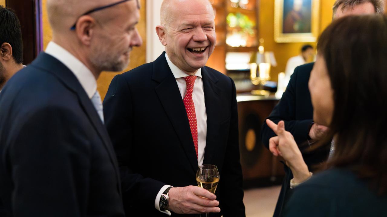 image of two people talking to someone with their back to the camera