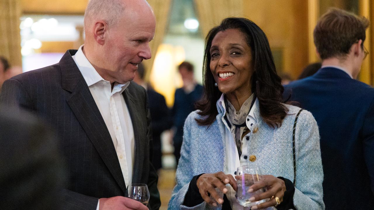 image of two people stood talking