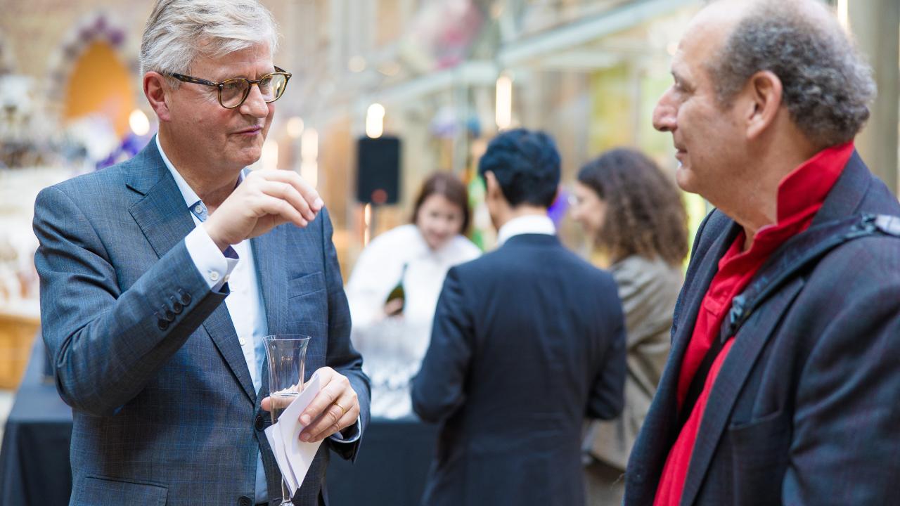 image of two men talking, one gesticulating with his hands