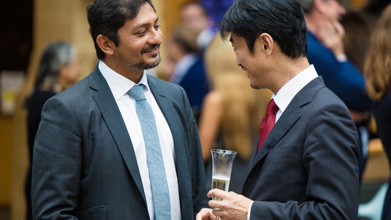 image of two men stood talking