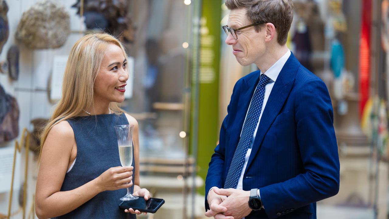 Image of a man and a woman stood talking