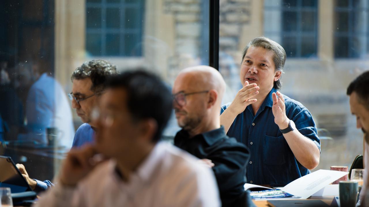 side image of a group of people sat listening to a lecture