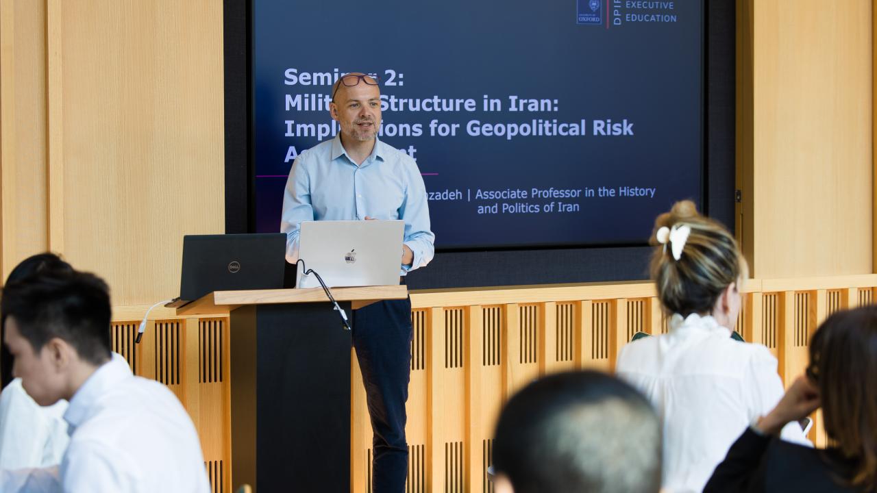 image of a man stood in front of a screen giving a lecture