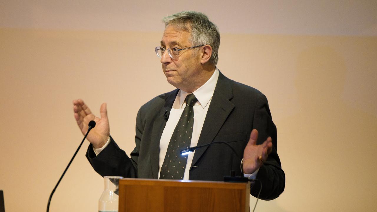 image of a man at a lectern giving a lecture