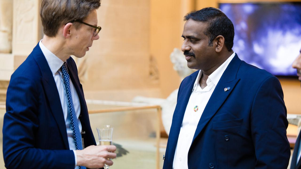 image of two men stood talking