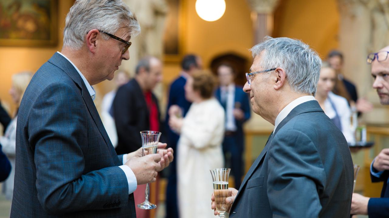 image of two men stood talking