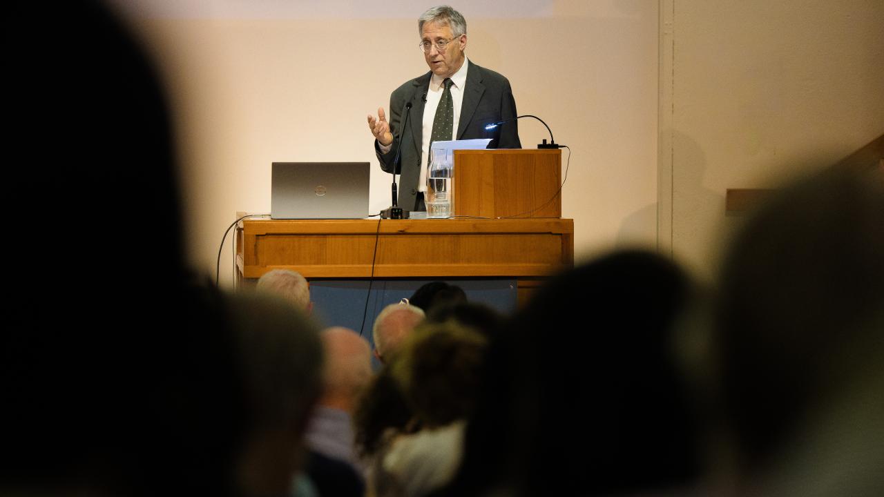 image of a man at a lectern giving a lecture