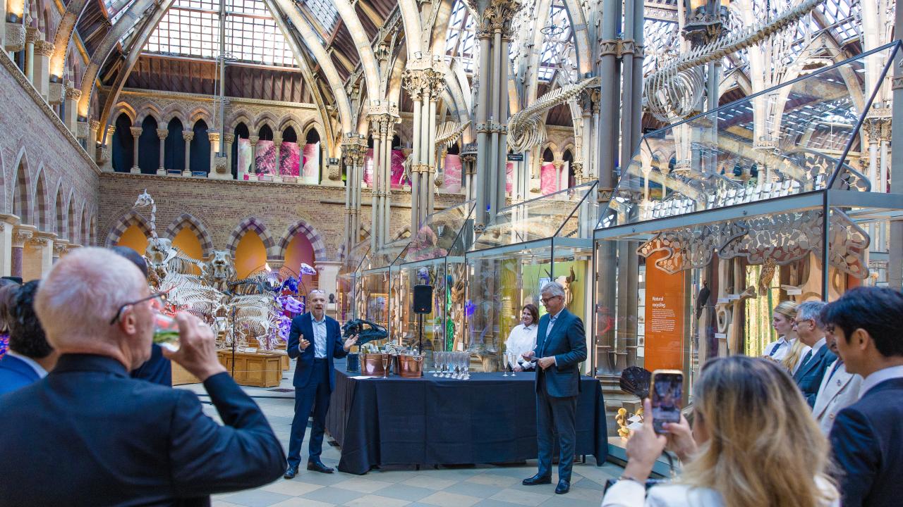 image of a man talking to an audience in an arched-roofed building
