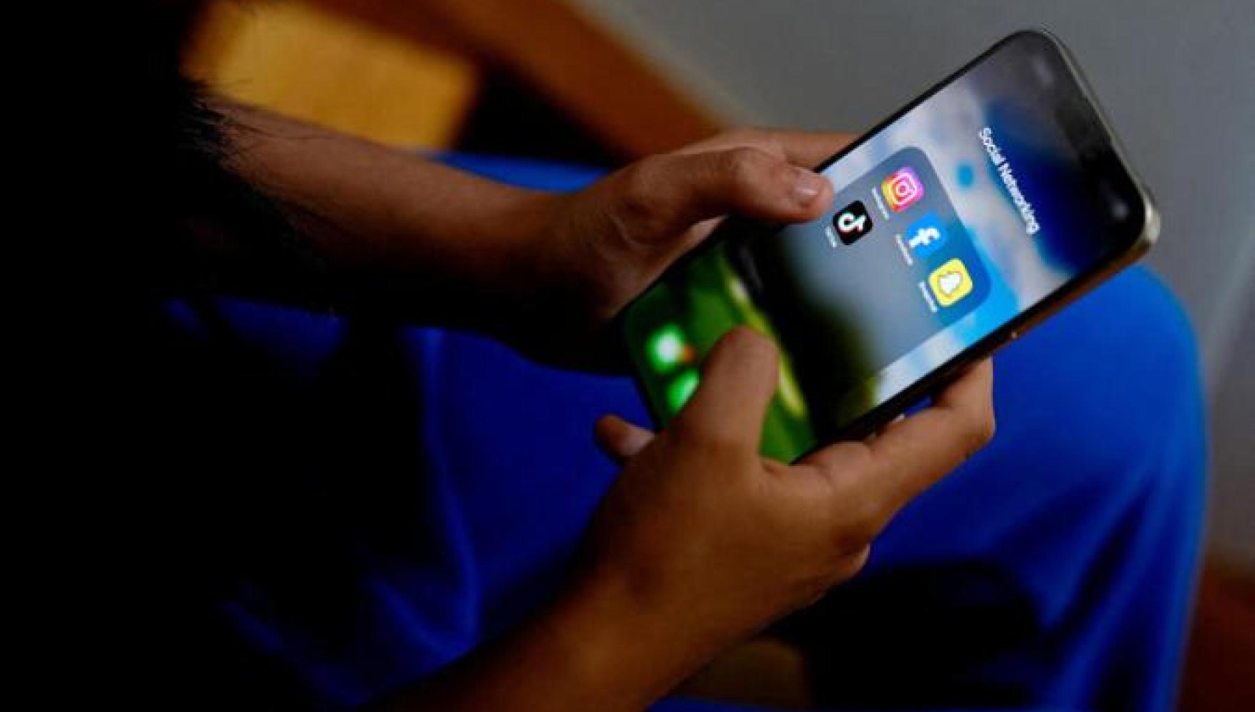 image of a pair of hands holding a mobile screen