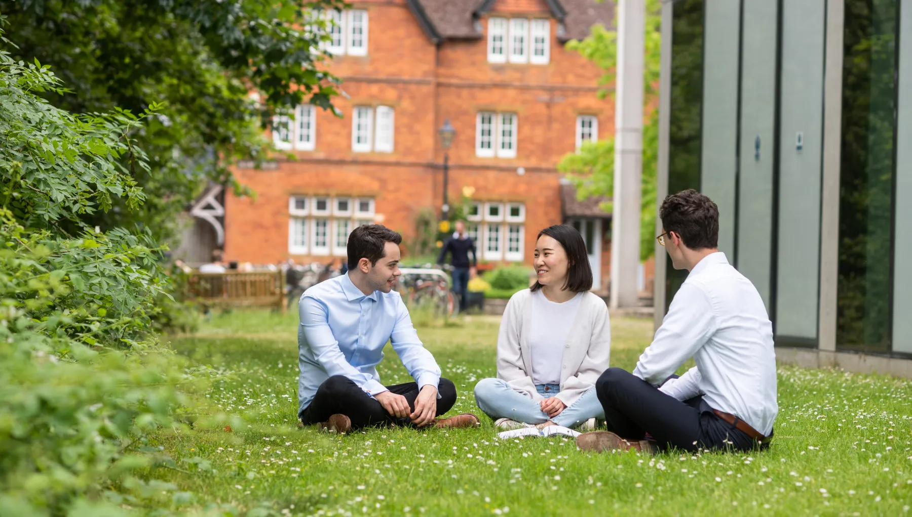 An image of students sat on the grass