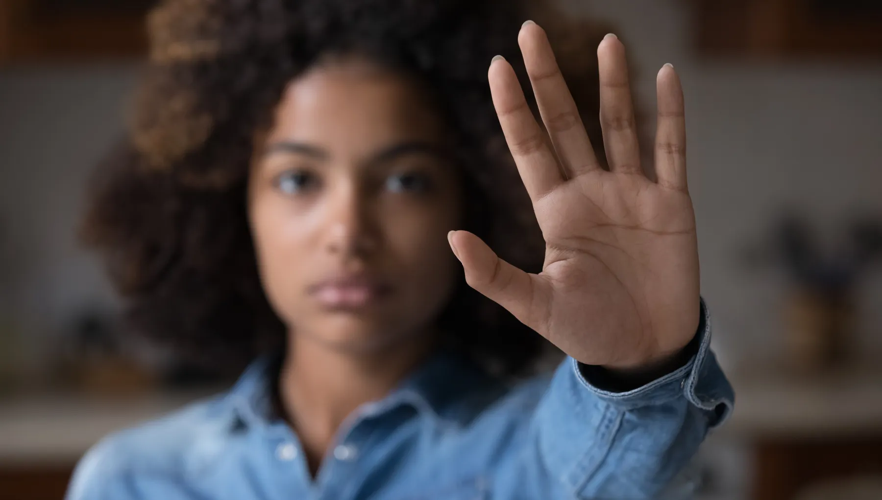 image of a woman with her hand stretched outward, palm open