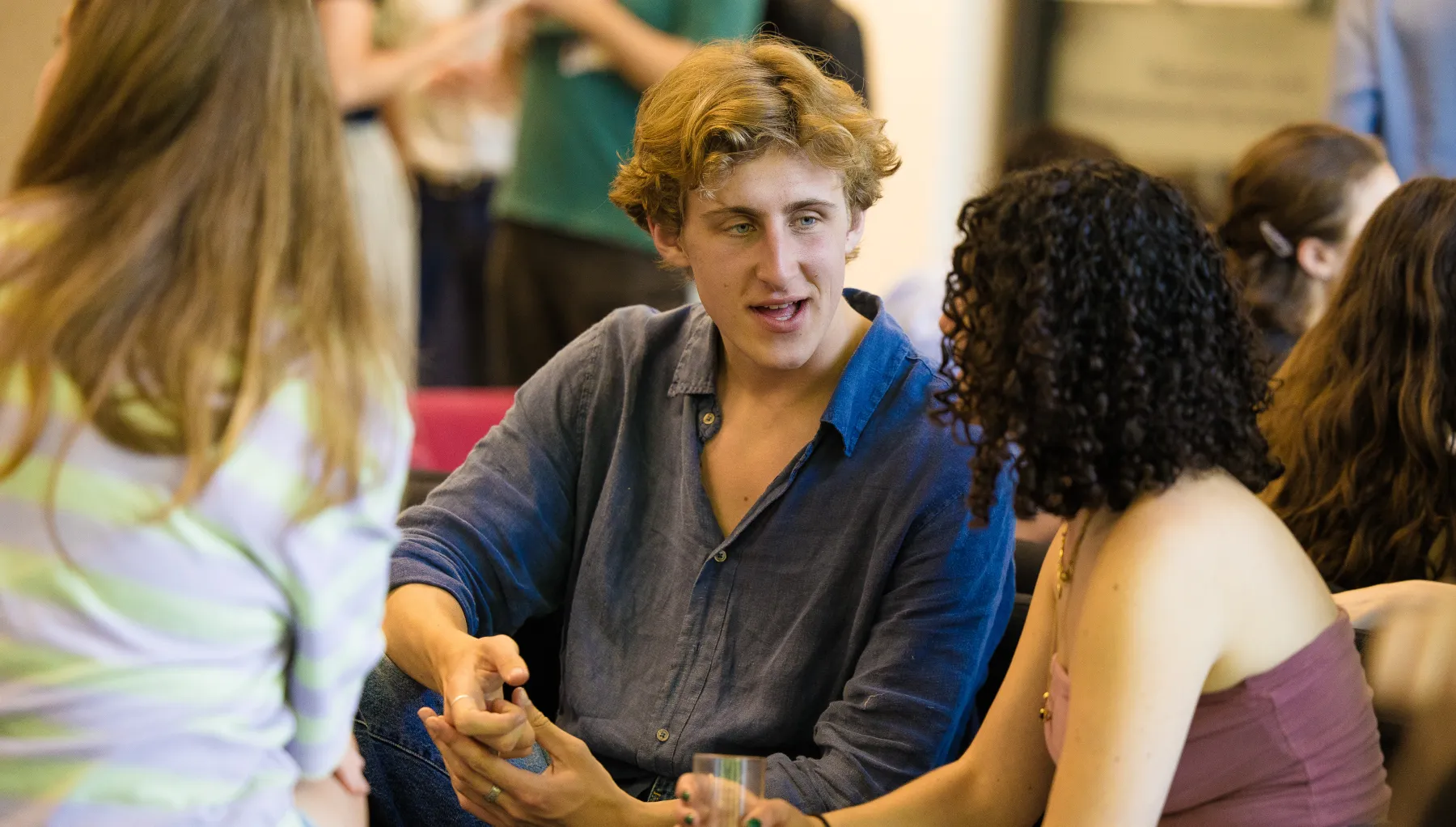 image of three students sat together talking