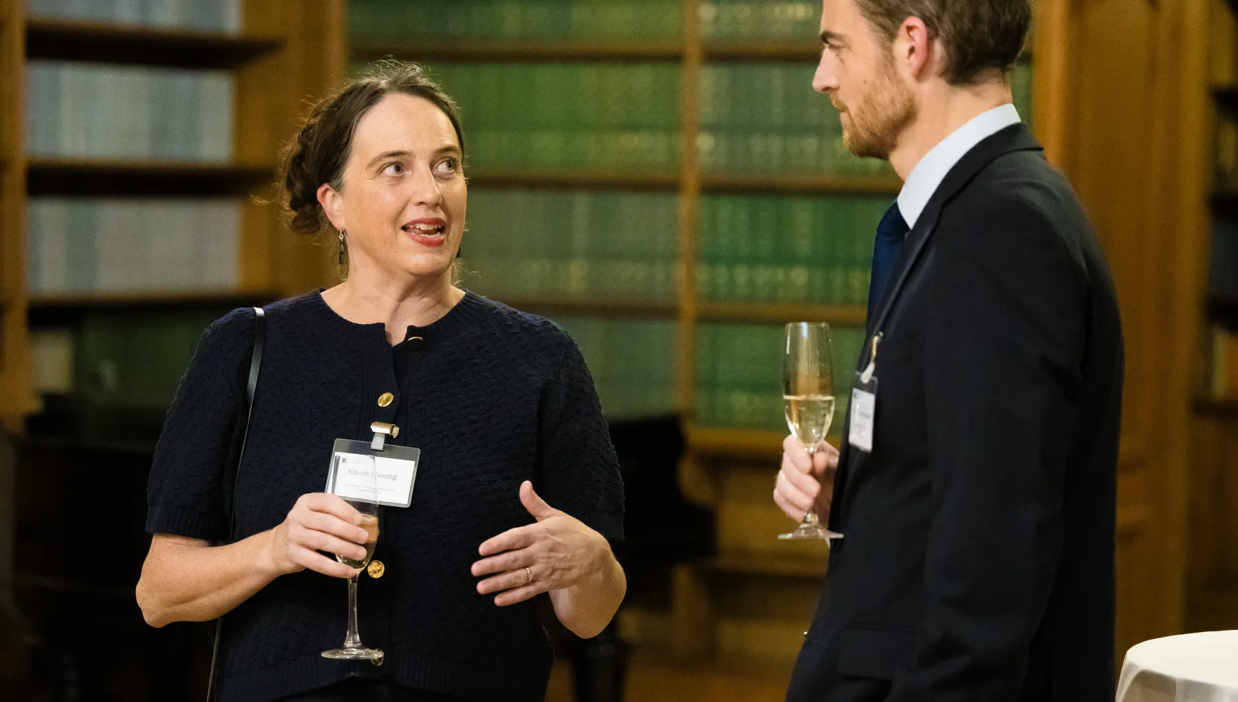 Image of a woman and a man stood talking to one another