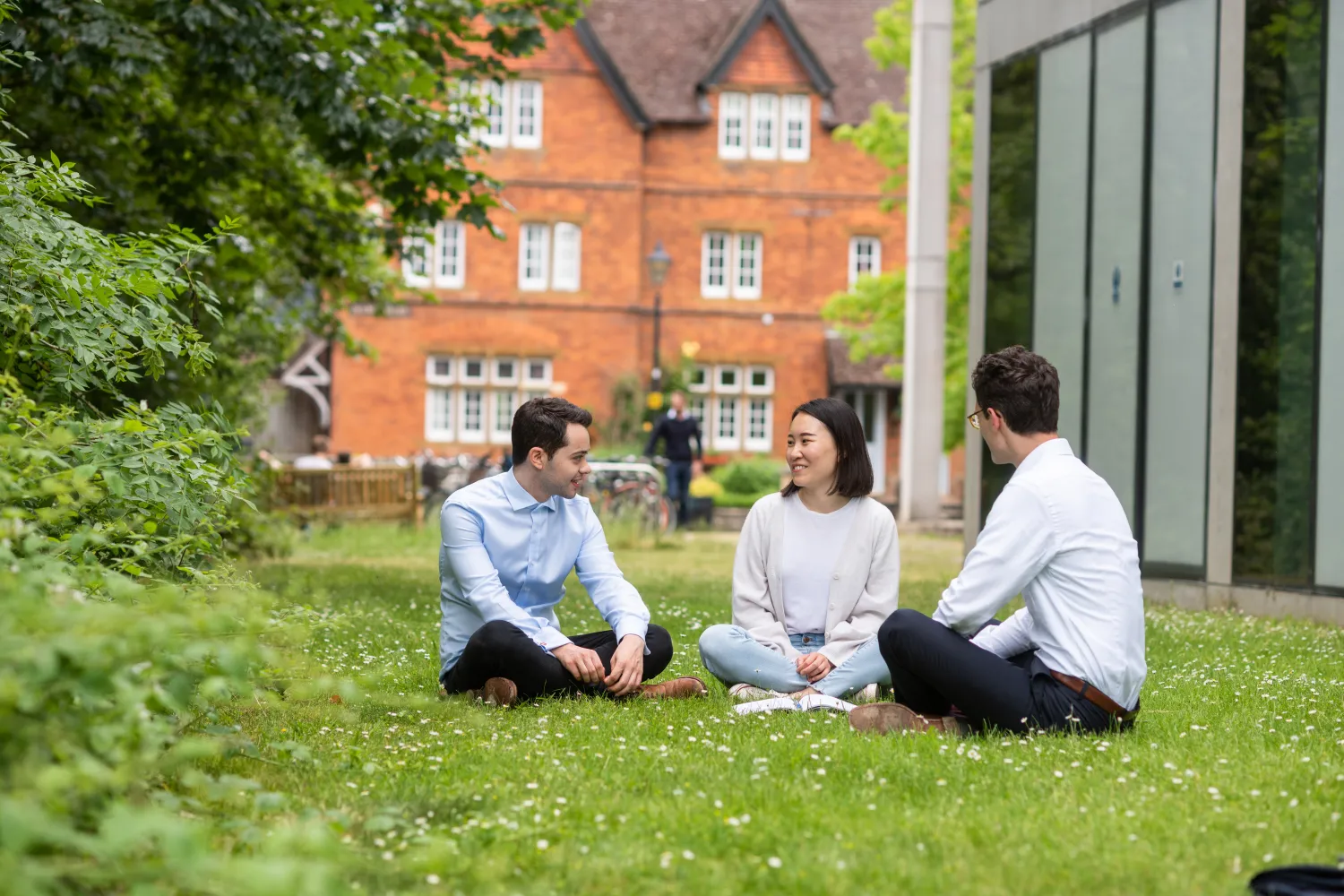 An image of students sat on the grass