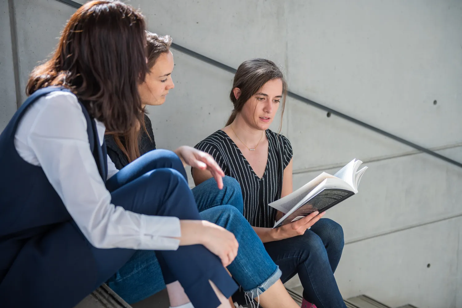 Image of three students on a flight of stairs