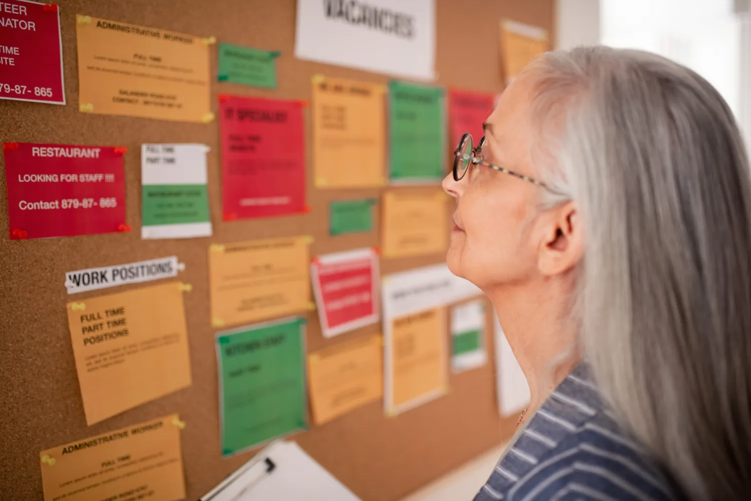 image of a woman looking at a jobs board