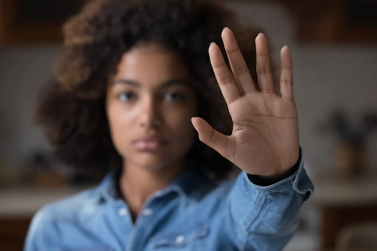 image of a woman with her hand stretched outward, palm open