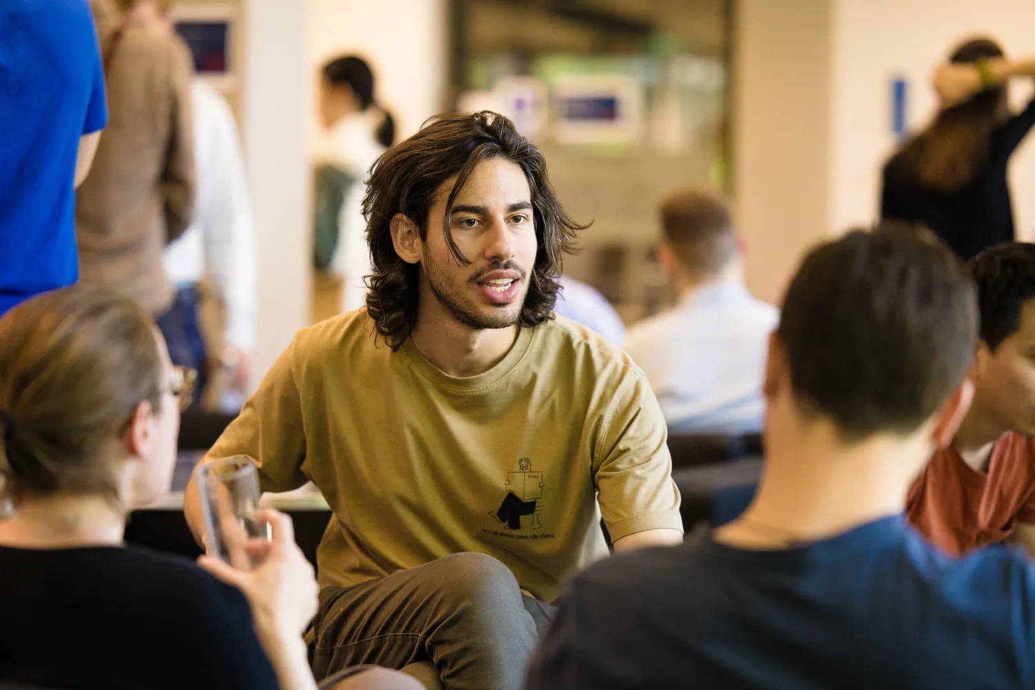 image of a few students sat talking together