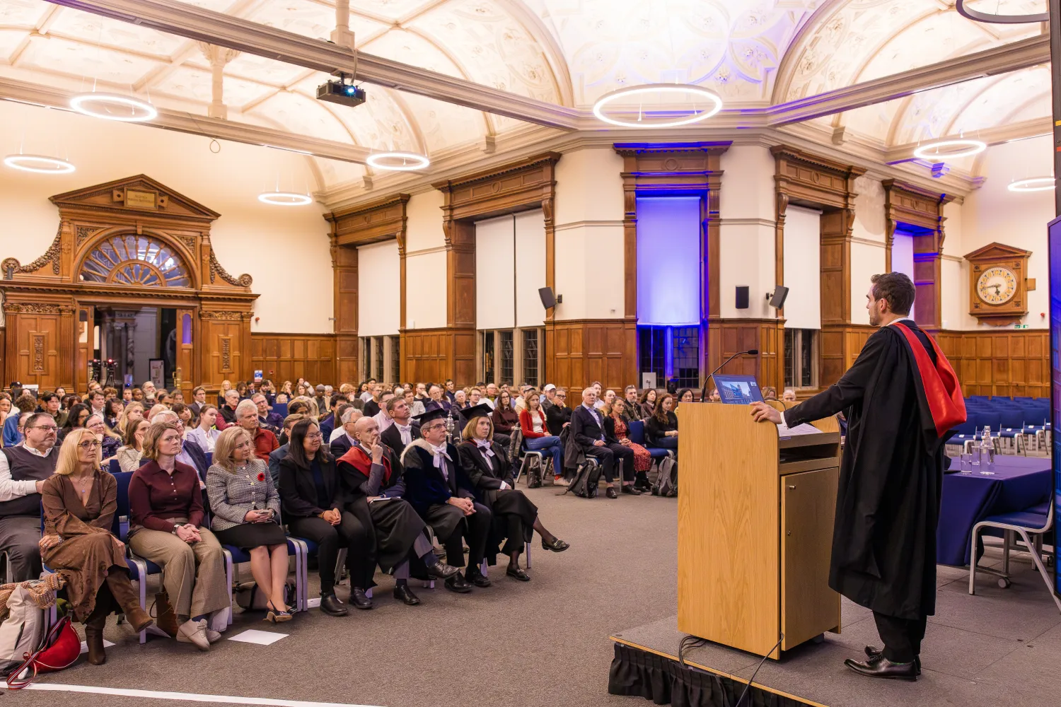 image of a man at a lectern in front of an audience
