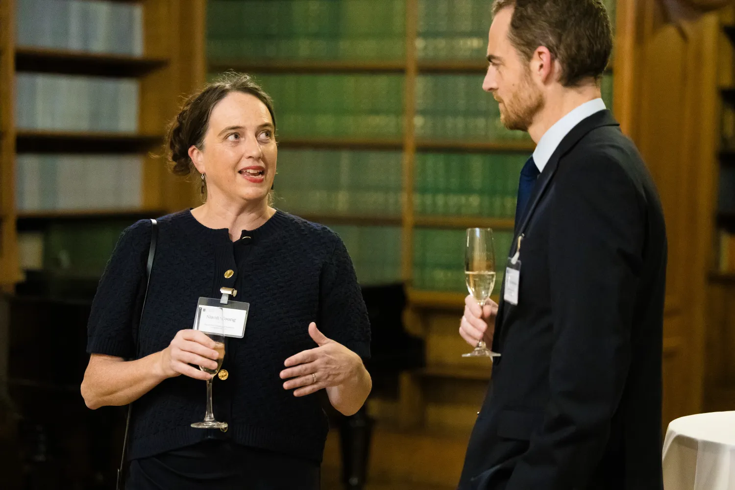 Image of a woman and a man stood talking to one another