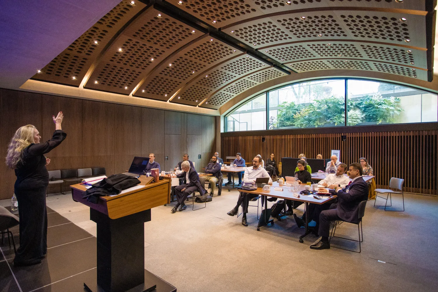 image of an audience in a room with a vaulted ceiling listening to a lecture